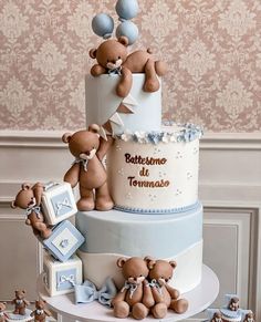 there is a three tier cake with teddy bears on the top and around it,