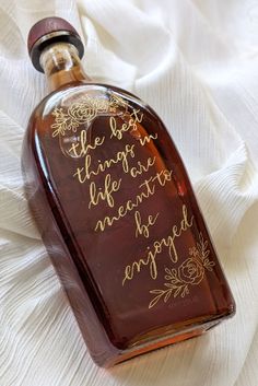 a bottle with writing on it sitting on a white cloth