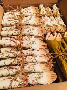 a box filled with lots of wooden utensils next to some cloth napkins