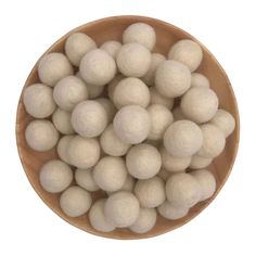 a wooden bowl filled with white cotton balls