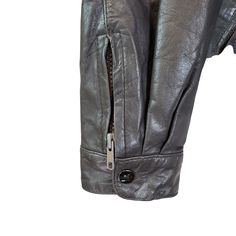 Classic asymmetrical zip moto jacket that is 100% leather and is fully lined. The inside has two open pockets. Zippers an snap closures at the wrists, adjustable waist with buckles and 3 zip closure pockets on the front. Hidden hood with zip closure. Great for a day on a motorcycle or just a pair with some jeans and boots for that moto vibe.This is in good condition with some faint wear on the leather, especially at the sleeve cuffs and some scratching on the hardware. Still has a lot of life in Leather Jacket With Zipper Pocket And Long Sleeves, Biker Outerwear With Asymmetrical Zip And Pockets, Biker Outerwear With Asymmetrical Zip, Asymmetrical Zip Biker Jacket With Pockets, Biker Leather Jacket With Asymmetrical Zip And Pockets, Leather Biker Jacket With Zipper Pocket, Winter Biker Jacket With Asymmetrical Zip And Pockets, Winter Leather Jacket With Asymmetrical Zip And Pockets, Winter Leather Jacket With Asymmetrical Zip