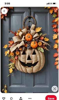 an image of a door decorated with fall leaves and a pumpkin wreath on it's front door