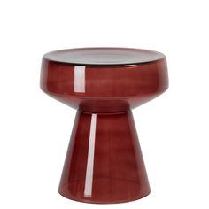 a small red stool sitting on top of a white floor