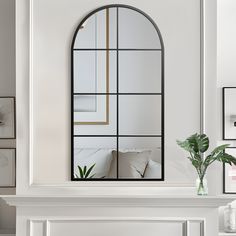 a living room filled with furniture and a large mirror on the wall above a fireplace