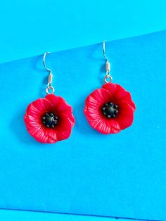 Beautiful Poppy Flower dangler earrings, to brighten up your day. Dainty and cute. The hook is made of plated sterling silver to protect your ears and the the Poppy Flower is made of resin They come well presented and wonderful for a birthday present for a friend, family or your loved one. I offer free postage and will despatch within a day of purchase Thank you for taking the time to look at my earrings and please visit my UK shop for more original designs.  Bespokedanglers. Thanks Sharlene xx Red Flower Drop Earrings, Red Flower Charm Earrings, Hypoallergenic Red Earrings For Gift, Handmade Red Flower Earrings For Gift, Handmade Red Flower Earrings As Gift, Red Flower Earrings For Gift, Red Flower Earrings As Gift, Red Flower Earrings With Ear Wire, Flower Drop Earrings With Ear Wire