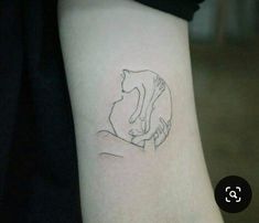 a woman's arm with a cat tattoo on the left side of her body