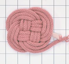 a pink rope with a wooden hook on top of it