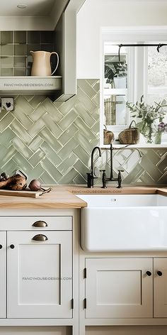 a kitchen with white cabinets and green tile backsplash, wooden counter tops and drawers