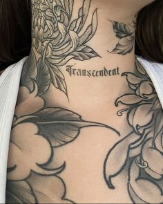 a woman's neck with flowers and words on it