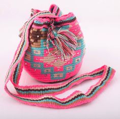 Beautiful Wayuu shoulder bag.  Made by Indigenous of the Wayuu tribe in Colombia and embellished by our artisans to give them a touch of uniqueness. It can be used with a smart casual, or casual dress code.  Dimensions: W: 8' inches/ 20 cm. L: 6'29 inches / 16 cm. Bohemian Pink Crossbody Shoulder Bag, Artisan Bag With Adjustable Strap For Festival, Artisan Festival Bag With Adjustable Strap, Pink Bohemian Crossbody Shoulder Bag, Pink Crossbody Shoulder Bag For Festival, Pink Bohemian Crochet Bag With Adjustable Strap, Pink Woven Shoulder Bag For Festival, Pink Handwoven Festival Bags, Pink Handwoven Bags For Festival