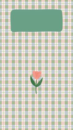 a pink flower sitting on top of a green and white checkered table cloth next to a