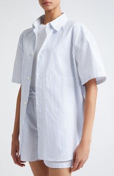 Allover stripes enliven this polished poplin shirt crafted in a longline silhouette with elbow-length sleeves. 31" length (size 38) Front button closure Spread collar Elbow-length sleeves 100% cotton Dry clean or machine wash, line dry Made in Portugal Vertical Stripes Shirt For Summer Workwear, Button-up Shirt With Signature Stripes For Work, Workwear Button-up Shirt With Signature Stripes, Modern Striped Shirt For Spring, Spring Workwear Top With Signature Stripes, Elbow Length Sleeve, Poplin Shirt, Striped Shorts, Long A Line