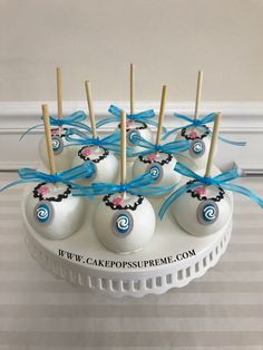 cake pops are arranged on a plate with toothpicks