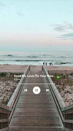 a wooden walkway leading to the beach with an mp3 player on it's side