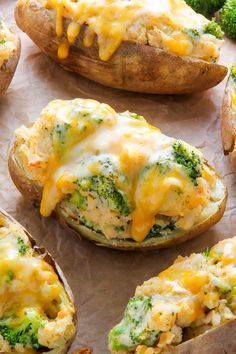 baked potatoes with broccoli and cheese on them sitting on a baking sheet, ready to be eaten