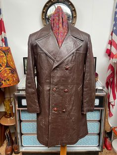 Fab and Funky Vintage early 1970s Made in Canada leather double breasted leather coat,coat has an impressive 6" inch wide lapels,football buttons,a dandy rear half belt and is really warm as it's part lined with acrylic and nylon,1 inside pocket. No rips,tears but the leather is well worn in places,mainly from the middle half down on the front and sides,the arms shoulders and rear of the cuffs,the whole of the back seems in great condition . Really quite heavy,around 2.6kg which will reflect in Retro Brown Double-breasted Outerwear, Vintage Brown Outerwear With Double Button Closure, Vintage Double-breasted Leather Jacket For Fall, Vintage Double-breasted Pea Coat With Double Button Closure, Vintage Brown Double-breasted Pea Coat, Vintage Brown Pea Coat For Fall, Retro Double-breasted Business Outerwear, Vintage Double-breasted Pea Coat, Vintage Long Pea Coat With Double Button Closure