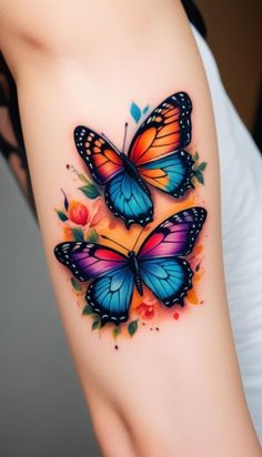 colorful butterfly tattoo on the side of a woman's stomach, with flowers and leaves around it