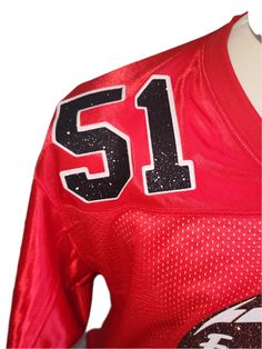 a football jersey with the number 51 on it and black letters that spell out,