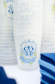 plastic cups with blue and white designs are stacked on top of each other in an instagram