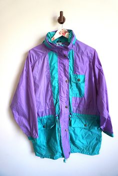 Jacket details: * Purple / green  raincoat parka * Zipper on front * pocket on front * Hood * Condition: Perfect vintage condition Measurements, laying flat: Length: 30 1/2" / 78 cm Armpit to armpit: 26" / 62 cm Cuff to shoulder: 22" / 53cm Label size: S / M  Feel free to message me with any questions Green Waterproof Windbreaker For Spring, Spring Green Waterproof Windbreaker, Spring Waterproof Green Windbreaker, Hooded Green Windbreaker For Rainy Weather, Green Weatherproof Windbreaker For Spring, Green Raincoat With Pockets For Hiking, Green Raincoat With Pockets For Spring, Green Long Sleeve Raincoat For Hiking, Green Long Sleeve Outerwear For Rainy Season