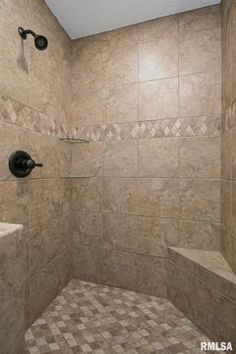 a walk in shower sitting next to a white sink and toilet under a skylight