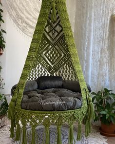 a green hammock hanging from the ceiling