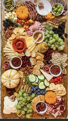 a platter filled with lots of different types of cheeses and meats on top of each other