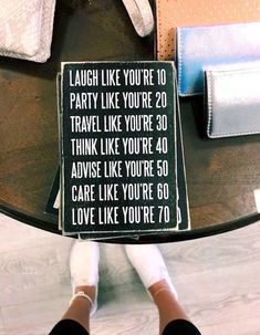 a sign that says, laugh like you're 20 party like you're 30 travel like you're 40 advise like you're 50 care like you're 60