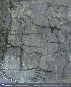 the rock face is very large and has many cracks in it