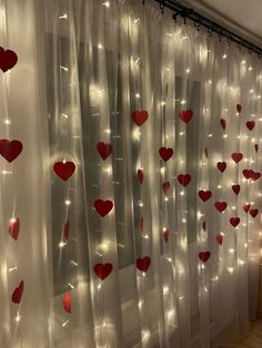 the curtains are decorated with red hearts and string lights on them for valentine's day