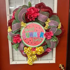 a wreath that says sweet summer time hanging on the front door with polka dots and flowers