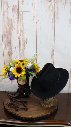 a hat and flowers are sitting on a table