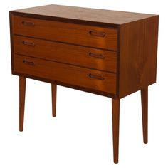 a wooden dresser with three drawers on one side and two legs at the other end