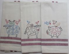 three hand towels with farm animals on them