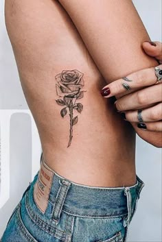 a woman with a rose tattoo on her stomach