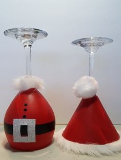 two wine glasses with santa hats on them