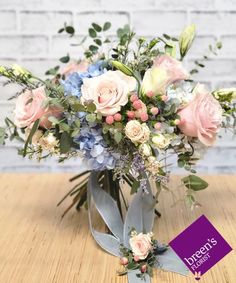 a bouquet of flowers sitting on top of a wooden table