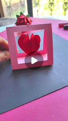 someone is making a valentine's card out of paper