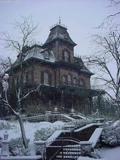 an old victorian house is covered in snow