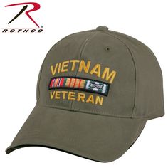 an army green vietnam veteran hat with the words vietnam and medal on it's side