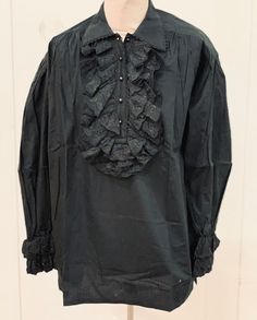 This is a high quality garment by SDL /Raven /Sacrifice. It is a black cotton mix with decorative frill around the front . It has black round bobble buttons. The sleeves also have a frilled cuff.This is a baggy fit. I have this in 2 sizes M chest 38/40 XL 46/48  Thank you for looking Gothic Long Sleeve Shirt For Halloween, Gothic Long Sleeve Cotton Shirt, Gothic Long Sleeve Top For Costume, Gothic Cotton Shirt For Alternative Fashion, Black Ruffled Top For Alternative Fashion, Black Gothic Tops For Larp, Black Cotton Shirt With Ruffles, Gothic Halloween Tops With Ruffles, Black Gothic Cotton Shirt