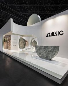 an exhibition stand with two circular sculptures on it's sides and the words aonic above them