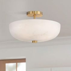 a light fixture in a room with white walls