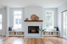 an empty living room with white walls and wood flooring is seen in this image