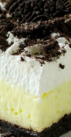 a piece of ice cream cake with oreo cookies on top and white frosting