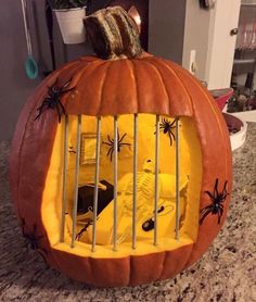 a pumpkin shaped like a jail cell with spider webs on it