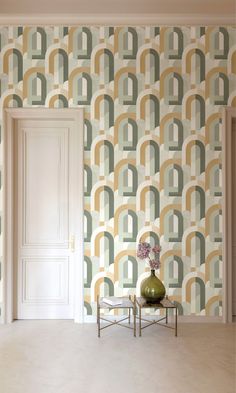 a living room with a vase and wall paper