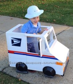 a little boy in a mail truck costume