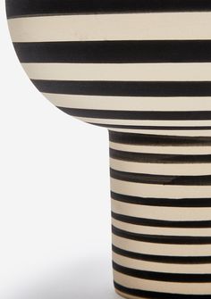 a black and white vase sitting on top of a table