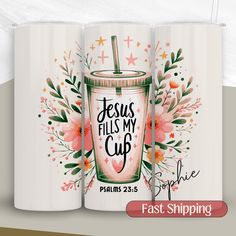 two white coffee mugs with the words jesus fills my cup on them and flowers